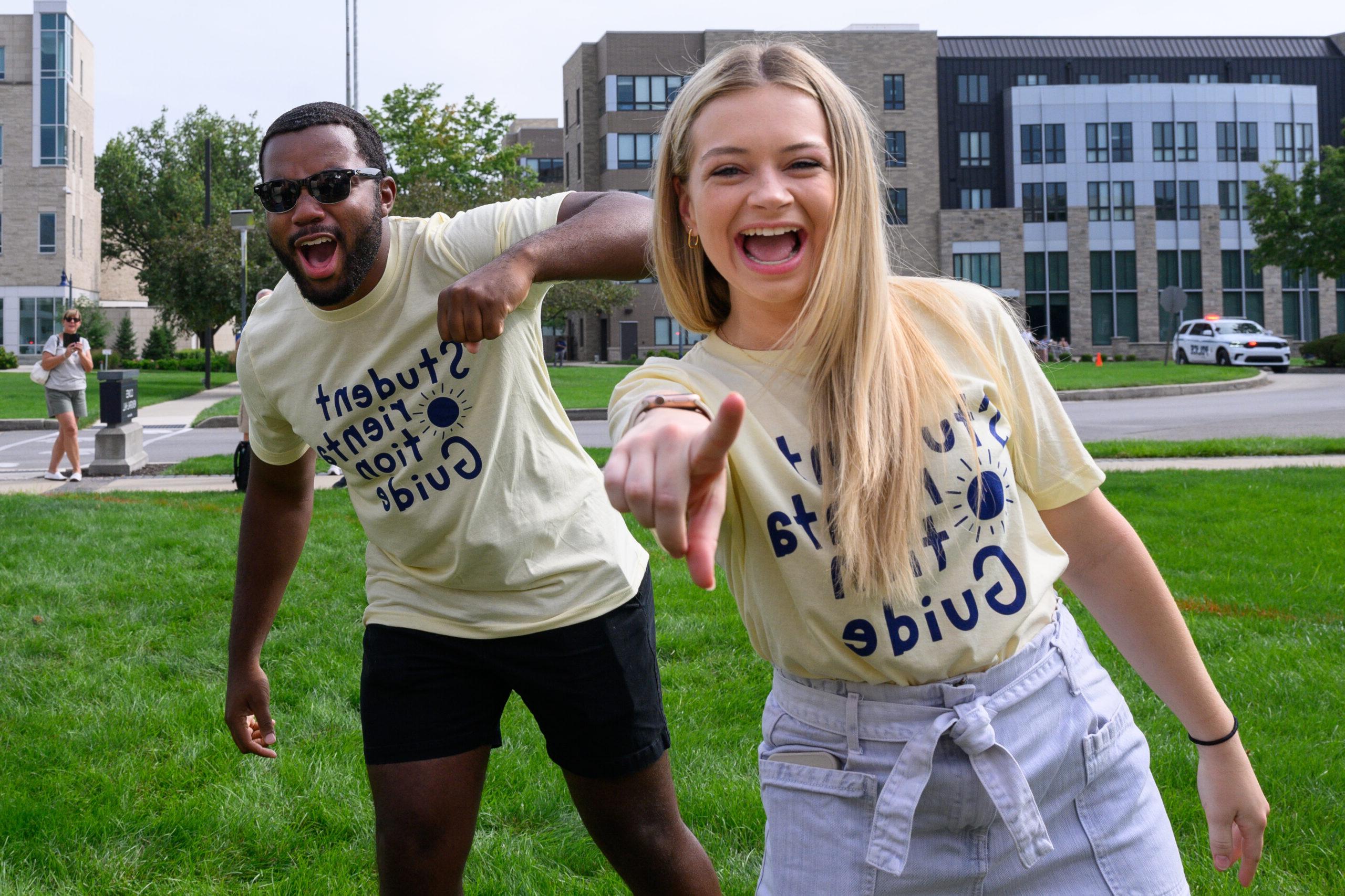 Female and male 亚博体育 student smiling at camera while outside.